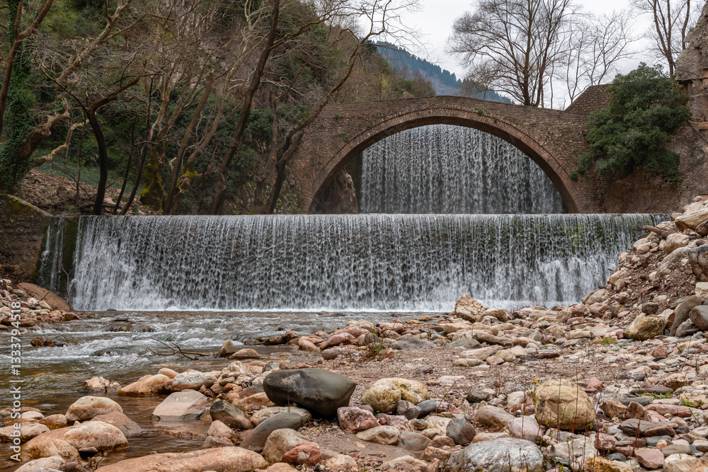 Palaiokarya stone arched bridge and waterfall near Pyli village, Thessaly, Greece