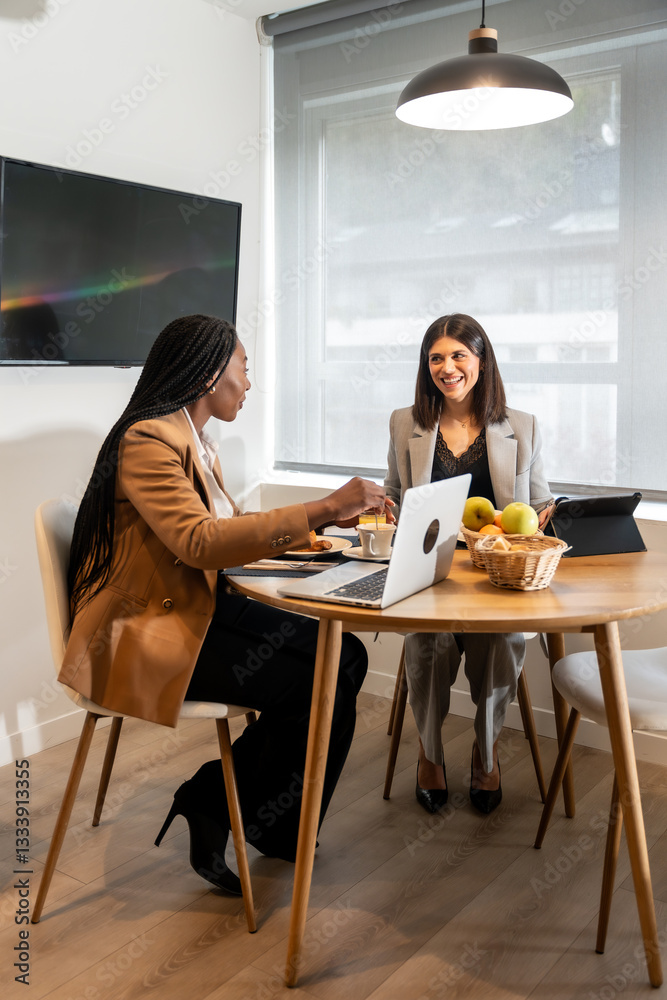 Businesswomen having breakfast and working on a business trip in hotel room Businesswomen having breakfast and working on a business trip in hotel room