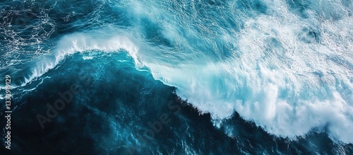  Aerial view of ocean waves, with deep blue and white colors, creating an atmospheric scene. 