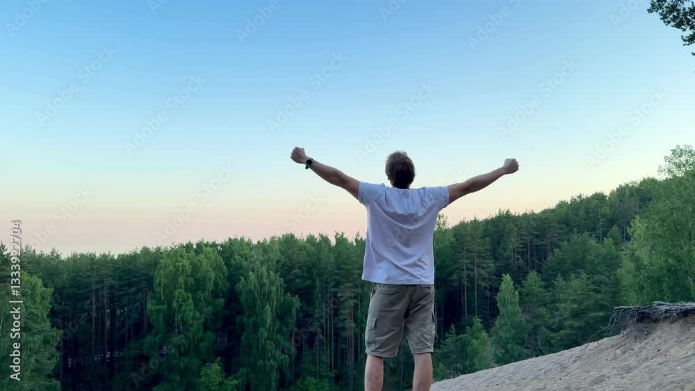 unrecognizable man on mountain raises hands up and feels happy unrecognizable man on mountain raises hands up and feels happy
