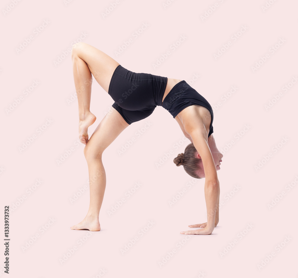 Young woman doing artistic gymnastics training, flexible rhythmic gymnast performing poses and showing skills and talent, sport workout, fitness and Well-Being concept, isolated on pink background Young woman doing artistic gymnastics training, flexible rhythmic gymnast performing poses and showing skills and talent, sport workout, fitness and Well-Being concept, isolated on pink background