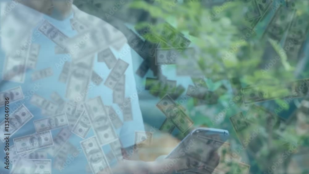 Using smartphone with dollar bills floating, person standing against green foliage Using smartphone with dollar bills floating, person standing against green foliage