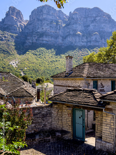Traditional Papigko village with stone buildings, narrow streets and mountain nature.