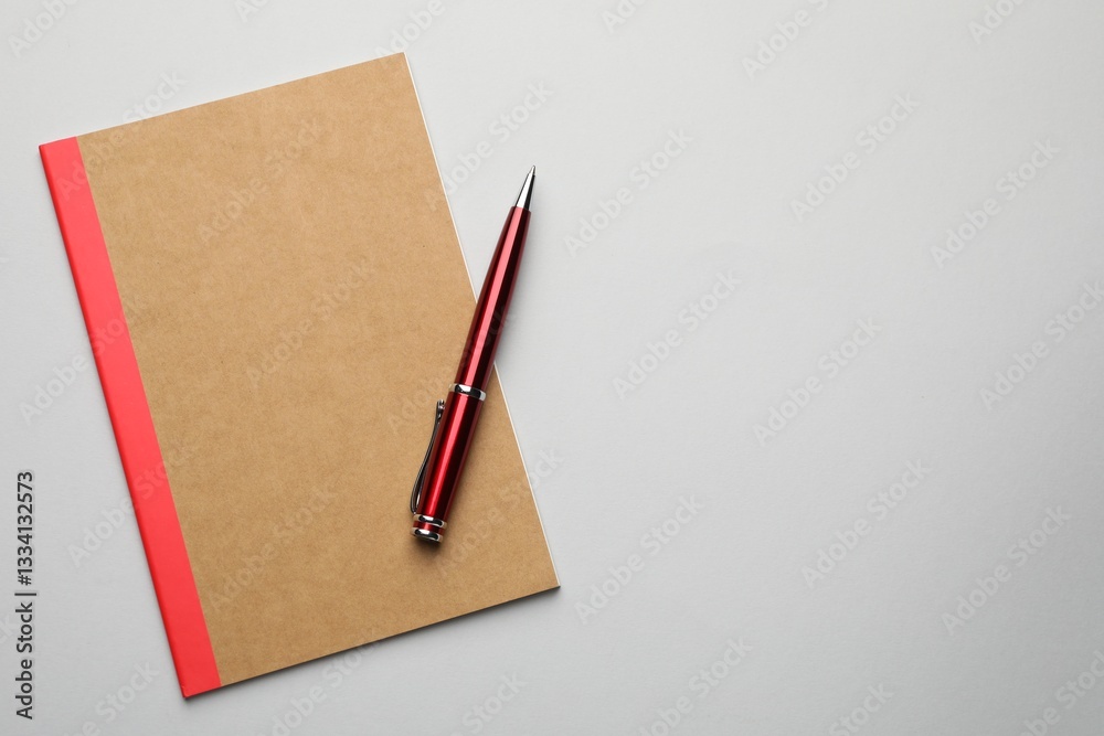 Copybook and pen on grey background, top view. Space for text Copybook and pen on grey background, top view. Space for text