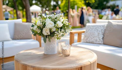 White roses centerpiece on wooden table at outdoor event
