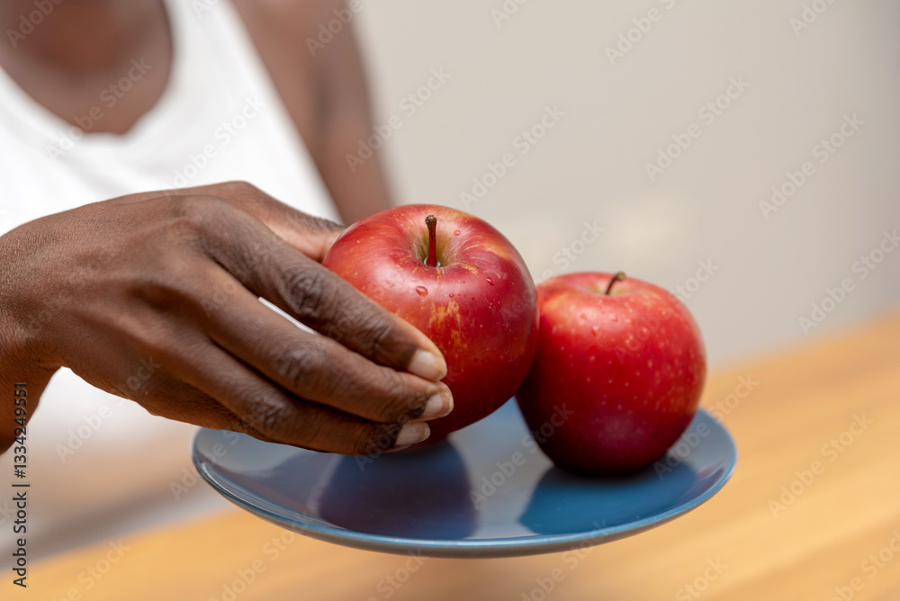 custom made wallpaper toronto digitalclose up of Woman's Hand Picking a Red Apple from a Blue Plate on a Wooden Table