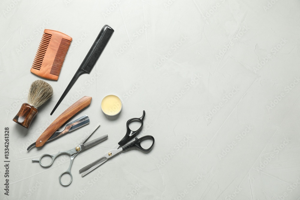 Many different barber's tools on light grey table, flat lay. Space for text Many different barber's tools on light grey table, flat lay. Space for text