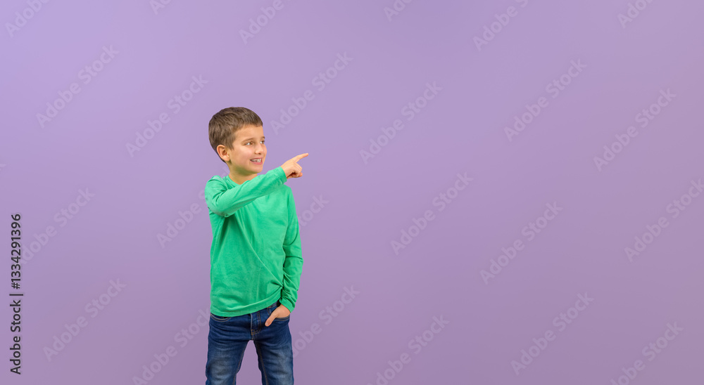 Portrait of smiling young businessman pointing away at copy space and advertising on purple background Portrait of smiling young businessman pointing away at copy space and advertising on purple background