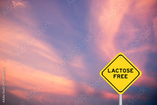 Yellow transportation sign with word lactose free on violet color sky background