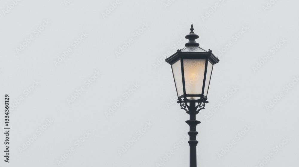 A black street lamp with a glass shade. A black street lamp with a glass shade.