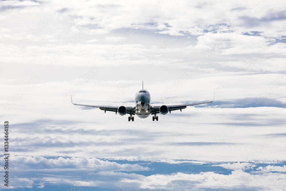 Airplane high in the cloudy sky. Travel and air travel concept.