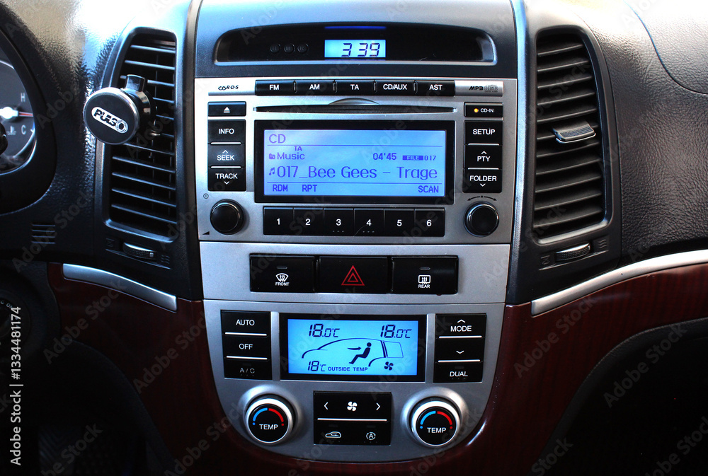 Old car multimedia system on dashboard. SUV control panel. Classic Vehicle Conditioner and climate control. Radio on control panel system in car. Multimedia control system. Old car multimedia system on dashboard. SUV control panel. Classic Vehicle Conditioner and climate control. Radio on control panel system in car. Multimedia control system.