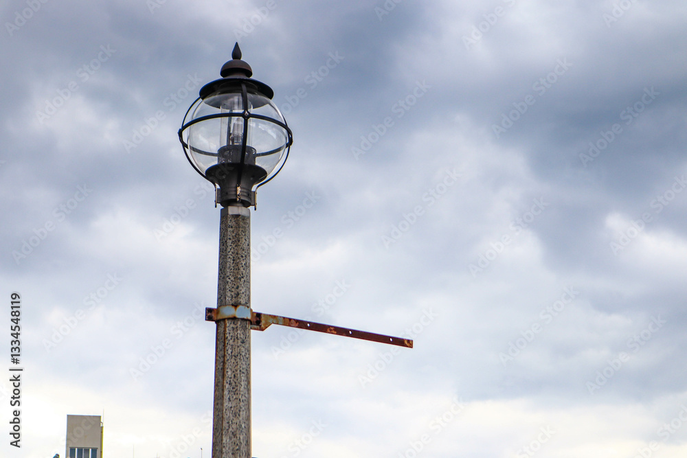 Lamppost with lamps on the background of the sky and spring bare branches. Lamppost with lamps on the background of the sky and spring bare branches.