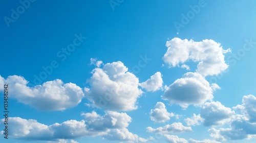 Fluffy clouds drifting in vibrant blue sky, serene atmosphere, perfect for relaxation, ideal for nature themes and tranquility.