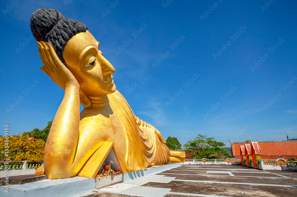 Lying golden Buddha statue in Wat Sri Sunthon temple on Phuket in Thailand. Gilded Buddha statue in Phuket, Thailand. Famous tourist place in Phuket.