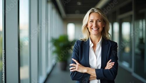 Flat Smiling mid aged businesswoman happy older lady entrepreneur and mature female executive manager stands with arms crossed in office looking at camera for portrait. concept as Smiling mid aged bus