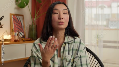 Overheated Asian Korean Chinese Japanese woman waving hand refresh tired lady sweaty female girl suffer of high temperature problem feel sweat hot without air conditioner climate control home indoors