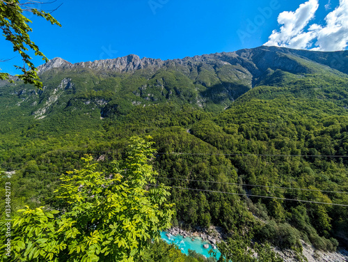 Soca Valley, Slovenia – Aerial view of the emerald-green Alpine River Soca on a bright sunny summer day with green foliage..The last wild river in Europe in Triglav National Park near the Vricic Pass
