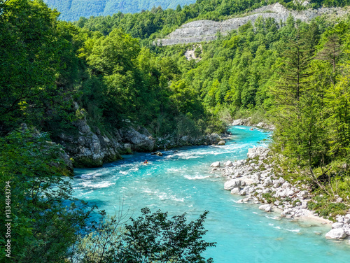 Soca Valley, Slovenia – Aerial view of the emerald-green Alpine River Soca on a bright sunny summer day with green foliage..The last wild river in Europe in Triglav National Park near the Vricic Pass
