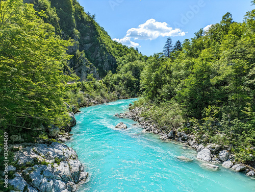 Soca Valley, Slovenia – Aerial view of the emerald-green Alpine River Soca on a bright sunny summer day with green foliage..The last wild river in Europe in Triglav National Park near the Vricic Pass