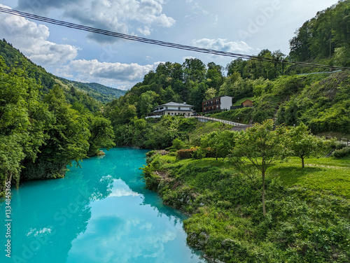 Soca Valley, Slovenia – Aerial view of the emerald-green Alpine River Soca on a bright sunny summer day with green foliage..The last wild river in Europe in Triglav National Park near the Vricic Pass