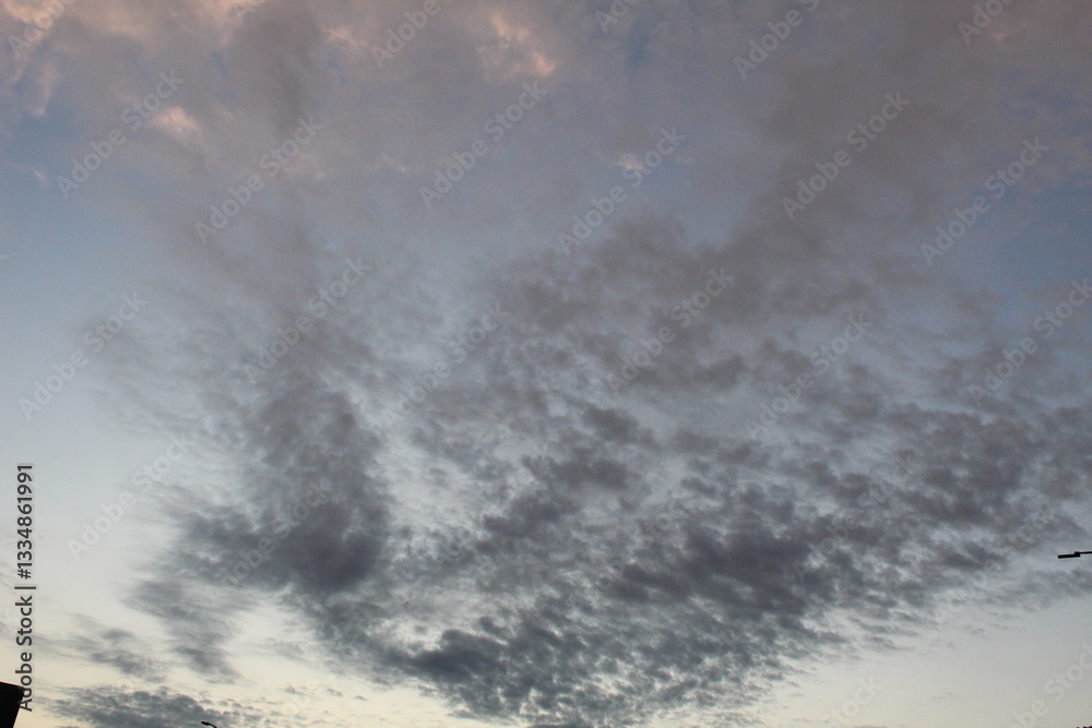 Fototapeta premium White bright clouds in a light blue sky. Beautiful sky