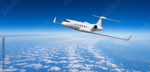 Foto White private jet flying above clouds in blue sky