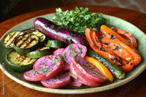 A vibrant plate of grilled vegetables: eggplant, zucchini, bell peppers, and purple potatoes, garnished with fresh parsley and arranged artfully on rustic green plate. photo