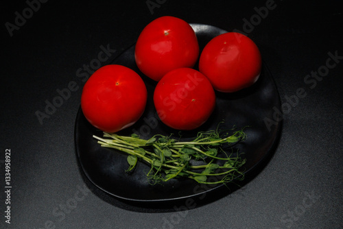 Organic ripe tomatoes with pea sprouts