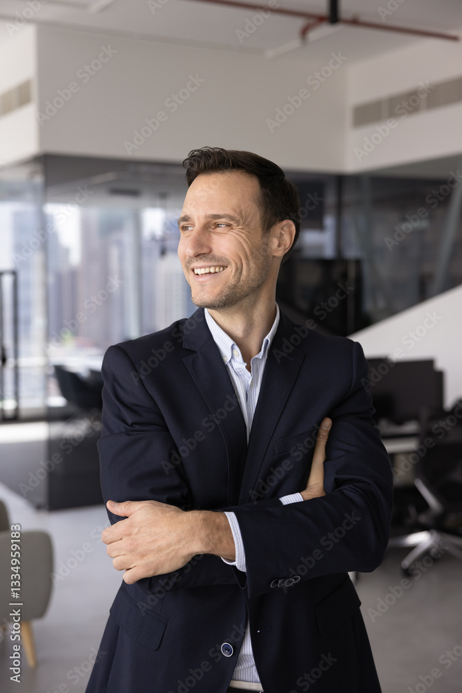 Fototapeta premium Cheerful confident Latin company executive man keeping arms folded at chest in confidence gesture, looking away, smiling, laughing, thinking on job success, successful work project. Vertical shot