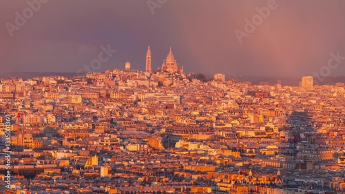 4K timelapse of Paris panorama during sunset golden hours, with clouds moving, dramatic light changing and sun rays walking over reaching the Sacre Coeur Basilica in the distance, skyline of Paris