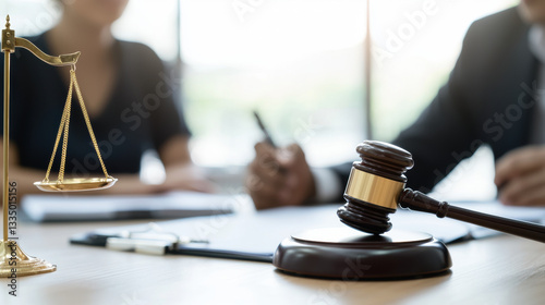 Gavel and scales in legal meeting setting