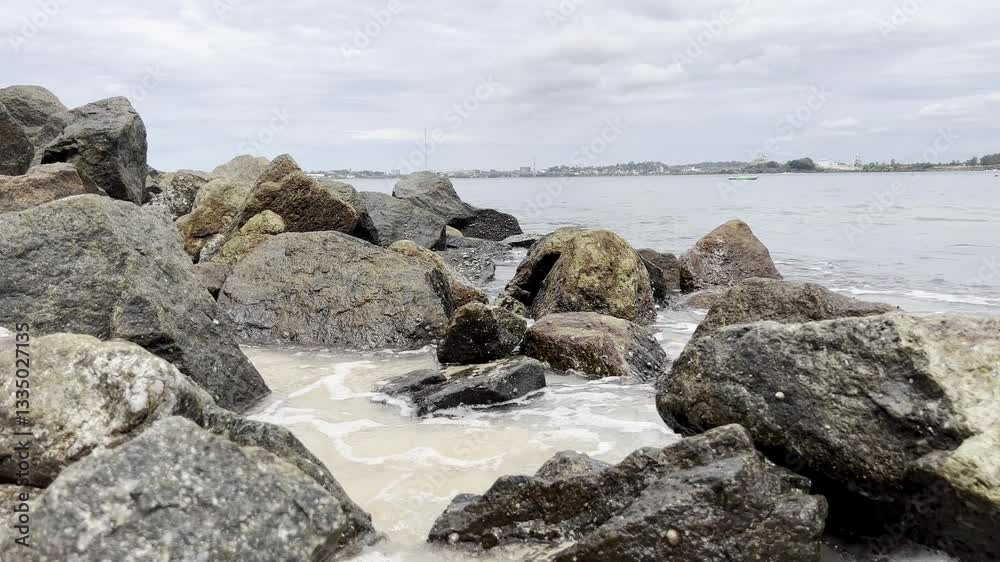 rocks stones on the ocean shore washed by waves atmosphere of summer vacation on the beach rocks stones on the ocean shore washed by waves atmosphere of summer vacation on the beach