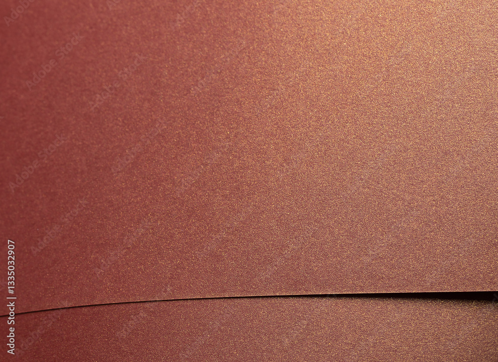 Fototapeta premium Burgundy paper background with a glossy, pearlescent texture and shimmering metallic finish. Rich, warm tones and sleek geometric lines create an elegant, luxurious design with subtle reflections and.