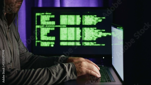 Hacker approaches computer and enters code to conduct cyber attack and hack bank account Hacker's hands enter malicious code that is displayed on the monitor Concept of hacker-cracker, side view