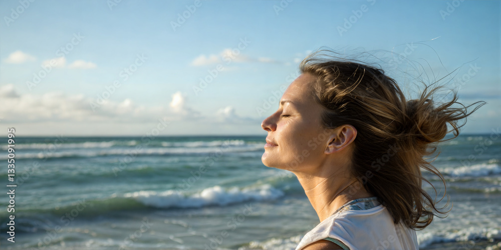 Woman meditating by the ocean with a peaceful expression at sunset Woman meditating by the ocean with a peaceful expression at sunset