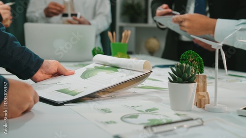 Engaging scene of a business meeting focusing on financial reports and sustainability strategies, showcasing teamwork and collaboration in a modern workspace. SACTR