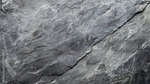 Textured Slate: A close-up of a weathered gray slate surface reveals a rough, textured finish with natural cracks and fissures, showcasing the beauty of geological formations.