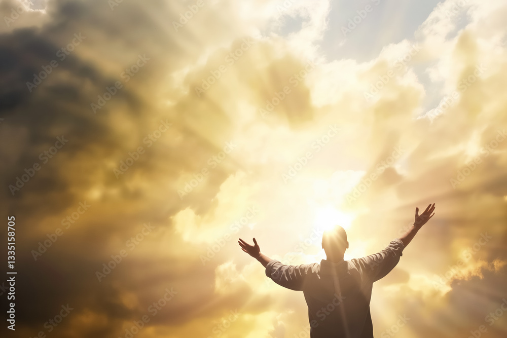 Silhouette of adult man embracing sunlight breaking through dramatic cloudy sky Silhouette of adult man embracing sunlight breaking through dramatic cloudy sky