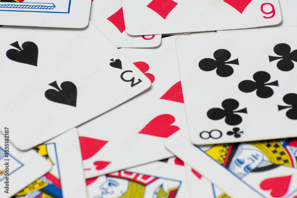 Scattered collection of playing cards, featuring various suits, numbers, and partial card faces. Chaotic arrangement creates a dynamic scene, symbolizing the unpredictability and thrill of card games Scattered collection of playing cards, featuring various suits, numbers, and partial card faces. Chaotic arrangement creates a dynamic scene, symbolizing the unpredictability and thrill of card games