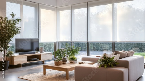 A cozy modern living room with sheer white roller blinds, letting soft light filter through the large windows