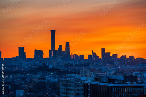 The context of dusk in Beijing, China: Ancient and modern buildings dance together in the radiance of the setting sun