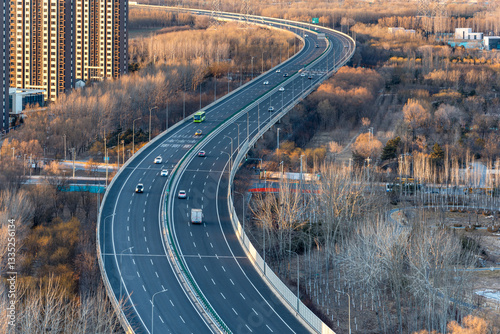 The winding viaduct in Beijing, China. The harmony between urban roads and nature. Jingping Expressway