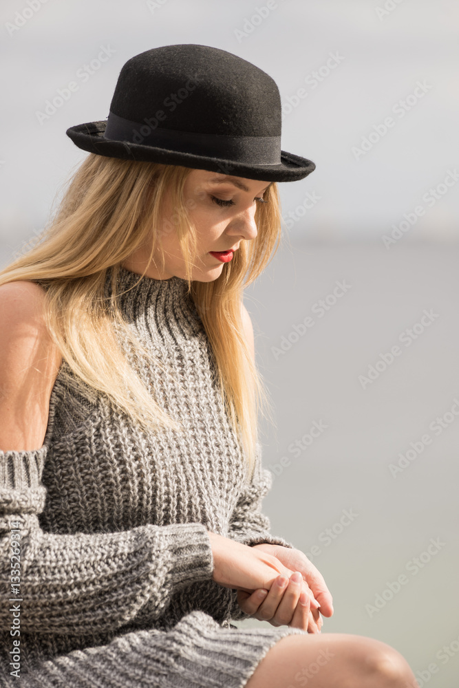 Woman wearing fedora and jumper outdoor