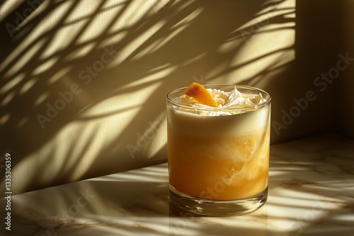 Refreshing Cocktail With Creamy Foam and Citrus Garnish on a Marble Table Wit...