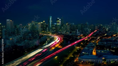 Timelapse of urban traffic moving along highways in a bustling metropolis at night