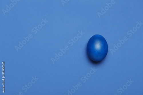 Painted Easter egg on blue ...