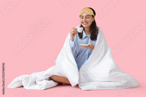Young woman in pajamas with...