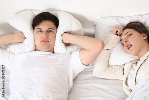 Young annoyed man suffering...