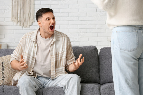 Angry young couple squabbli...